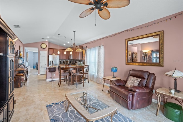 living room featuring vaulted ceiling and ceiling fan