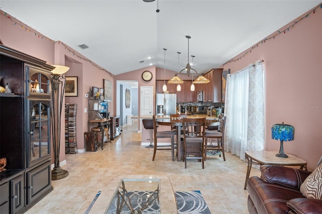 dining area with vaulted ceiling