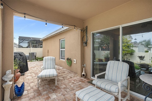 view of patio / terrace featuring a grill and cooling unit