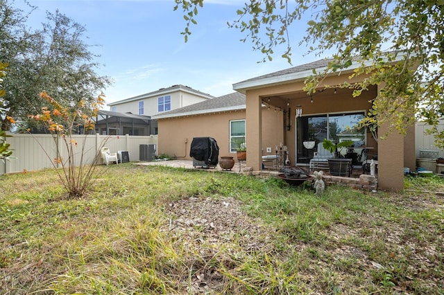 rear view of property featuring a patio area and central air condition unit