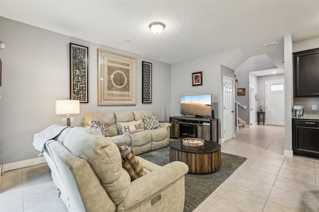 living room with light tile patterned floors and a textured ceiling