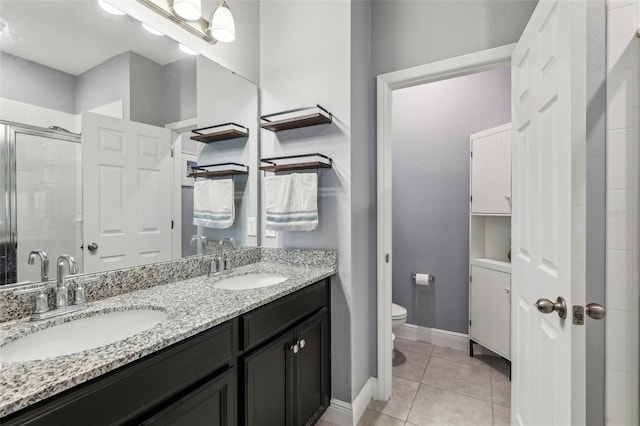 bathroom with vanity, toilet, an enclosed shower, and tile patterned flooring