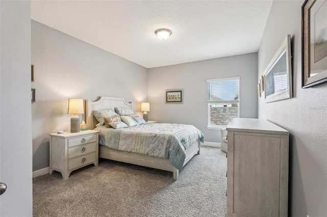 bedroom with a textured ceiling and light colored carpet