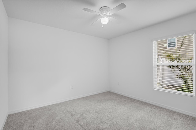 spare room featuring ceiling fan and carpet floors