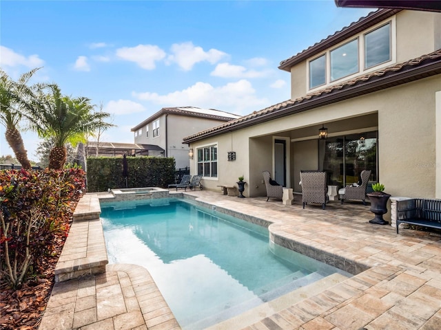 view of swimming pool featuring a patio area and an in ground hot tub