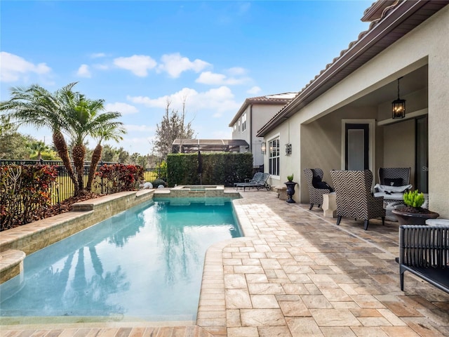 view of pool with an in ground hot tub and a patio