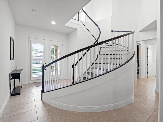 stairs with french doors and tile patterned flooring