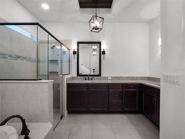 bathroom featuring vanity, a tile shower, and tile patterned floors