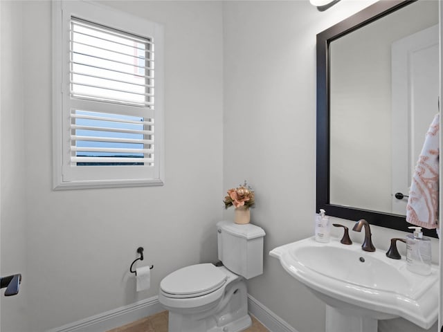 bathroom with sink, radiator heating unit, tile patterned floors, and toilet