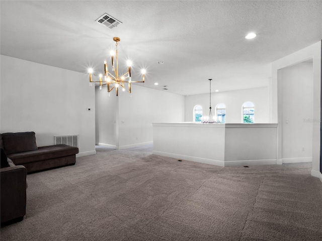 living room featuring a chandelier, carpet floors, and a textured ceiling