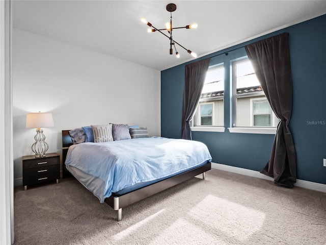 carpeted bedroom with an inviting chandelier