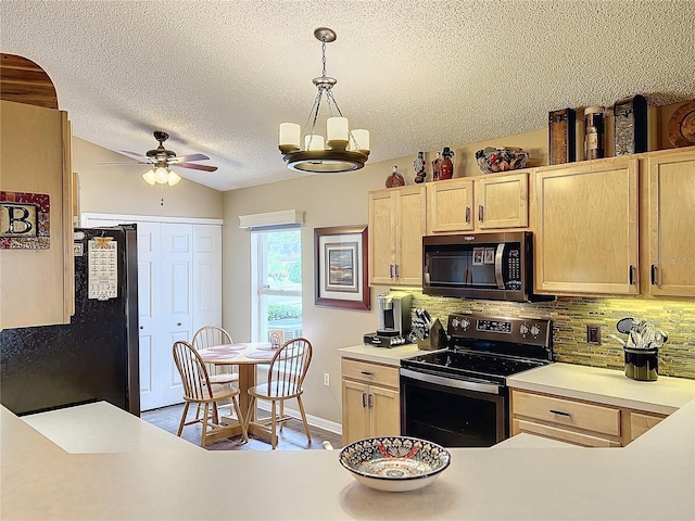 kitchen featuring stainless steel appliances, pendant lighting, light brown cabinets, and tasteful backsplash