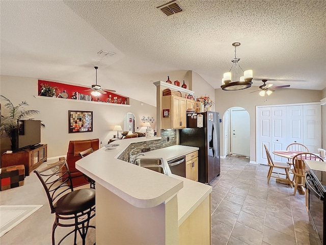 kitchen featuring appliances with stainless steel finishes, sink, hanging light fixtures, kitchen peninsula, and a breakfast bar