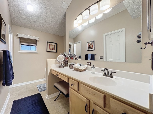 bathroom with vanity, tile patterned floors, and a textured ceiling