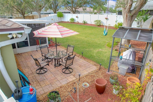 view of patio / terrace featuring a grill and a sunroom