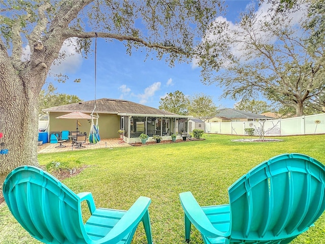 view of yard featuring a patio area and a sunroom