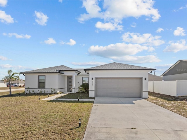 view of front of home with a front lawn and a garage