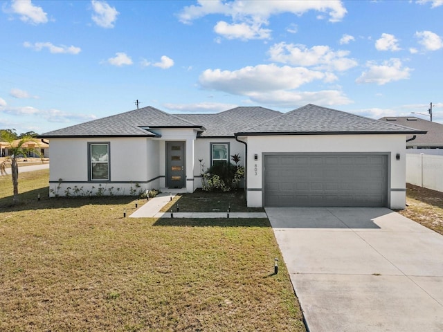 view of front of home featuring a garage and a front lawn