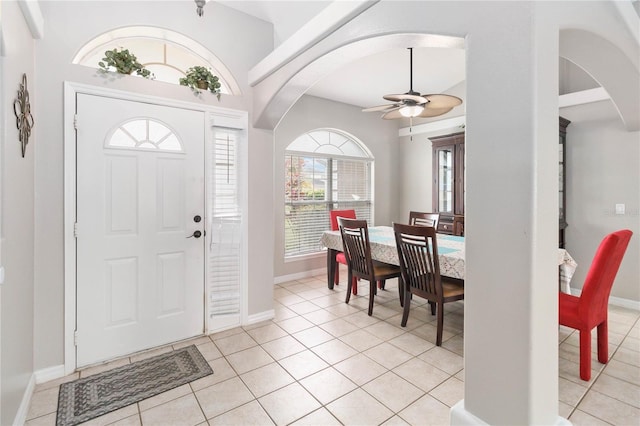 foyer entrance featuring ceiling fan, light tile patterned floors, and a wealth of natural light