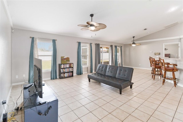 living room with ceiling fan, light tile patterned flooring, and lofted ceiling