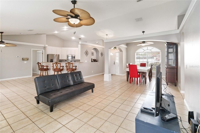 living room featuring vaulted ceiling and light tile patterned flooring