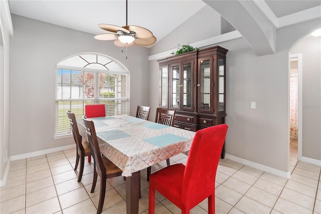 tiled dining room with ceiling fan and lofted ceiling