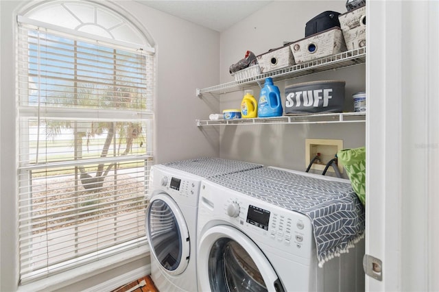 clothes washing area with washing machine and clothes dryer