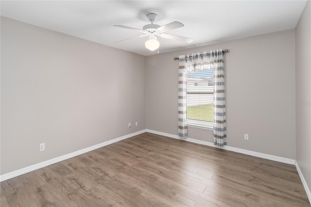 spare room with hardwood / wood-style flooring and ceiling fan