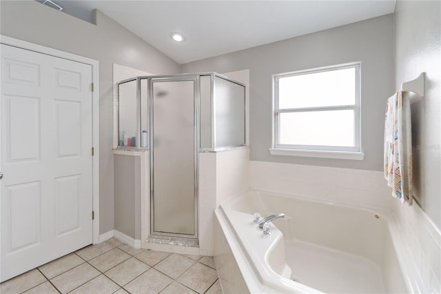 bathroom featuring tile patterned flooring, separate shower and tub, and lofted ceiling