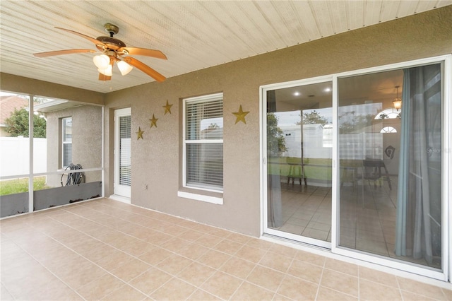 unfurnished sunroom with ceiling fan and wood ceiling