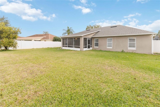 back of house featuring a sunroom and a yard