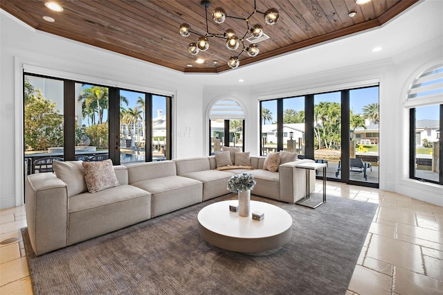 living room with a raised ceiling, wood ceiling, crown molding, a chandelier, and recessed lighting