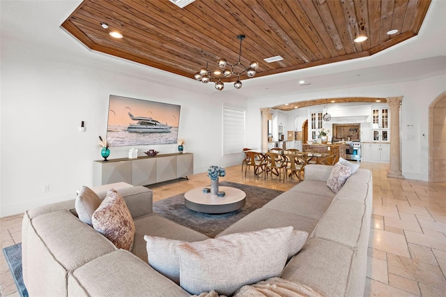 living area featuring a chandelier, arched walkways, wooden ceiling, recessed lighting, and a raised ceiling