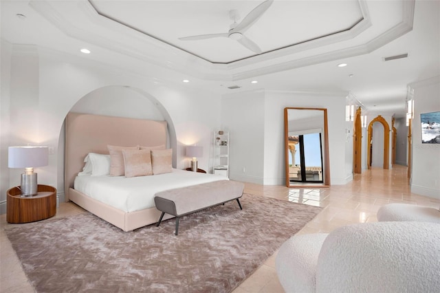 bedroom with light tile patterned floors, visible vents, a tray ceiling, and crown molding