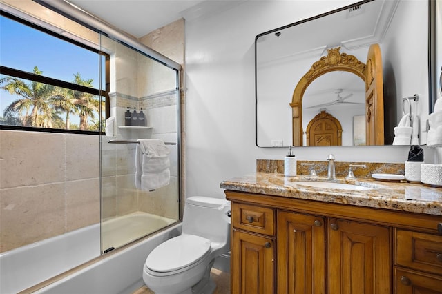 full bath featuring toilet, visible vents, bath / shower combo with glass door, and vanity