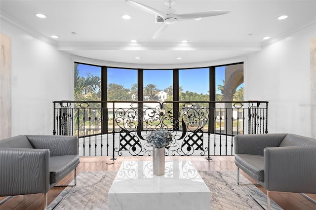 living area featuring ceiling fan, recessed lighting, an upstairs landing, ornamental molding, and light wood-type flooring