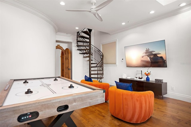 recreation room featuring recessed lighting, baseboards, crown molding, and wood finished floors