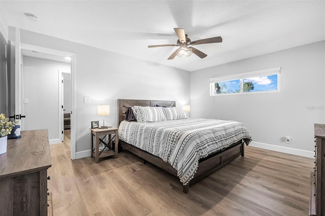 bedroom featuring ceiling fan and hardwood / wood-style flooring