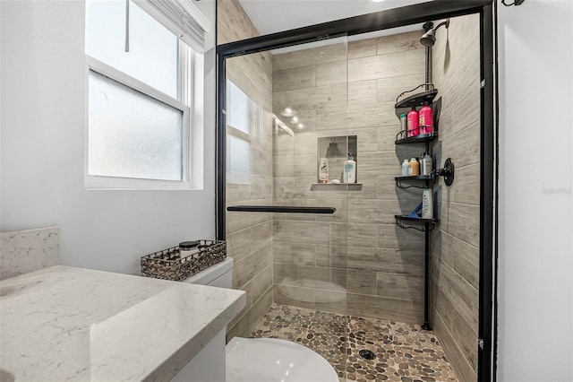 bathroom with toilet and walk in shower