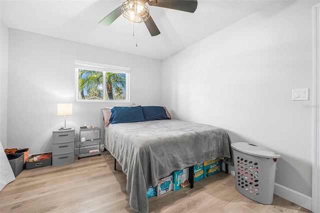 bedroom with light wood-type flooring and ceiling fan