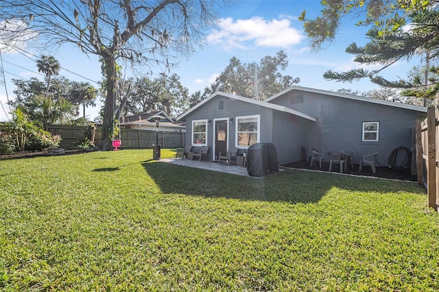 rear view of property featuring a lawn