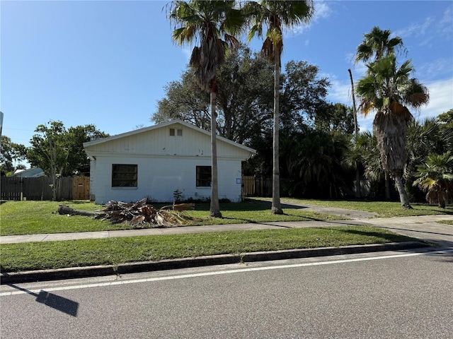 view of side of home with a lawn