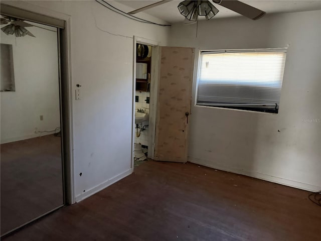 unfurnished bedroom with ceiling fan and dark hardwood / wood-style flooring