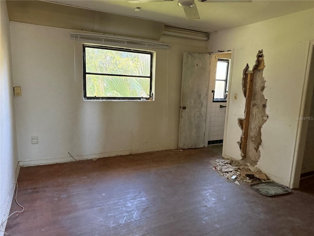 spare room with ceiling fan, a wealth of natural light, and hardwood / wood-style flooring