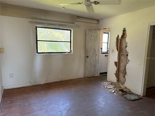 empty room with hardwood / wood-style floors and ceiling fan