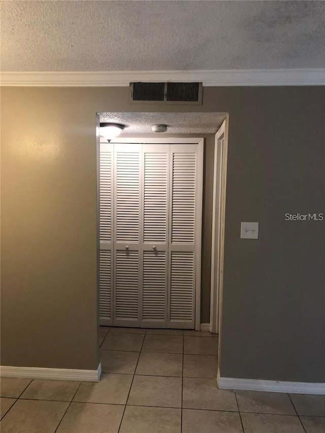 details featuring a textured ceiling and ornamental molding