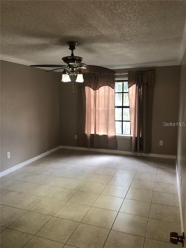 tiled spare room with a textured ceiling, ceiling fan, and ornamental molding