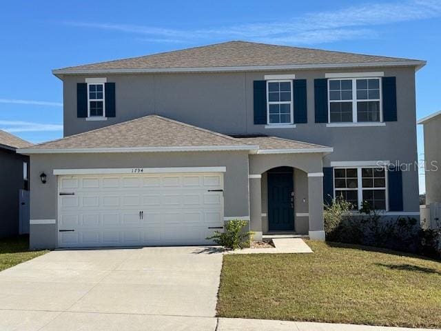 view of front property with a front yard and a garage