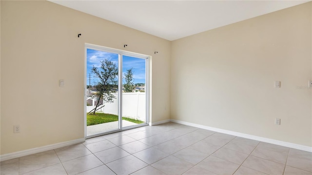 unfurnished room featuring light tile patterned flooring