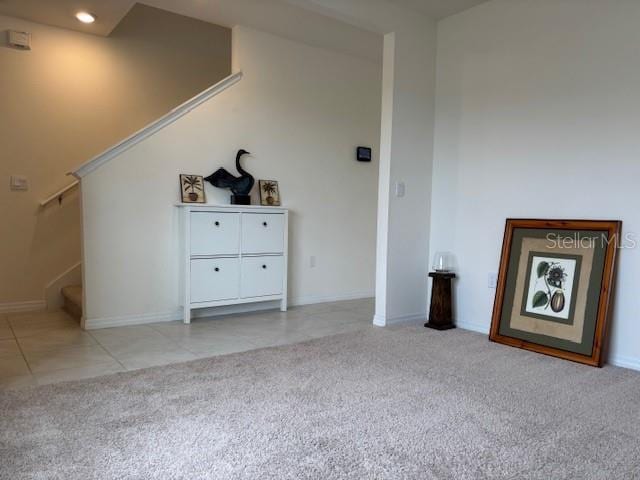 unfurnished living room with light colored carpet